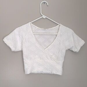 Reserved white textured wrap top